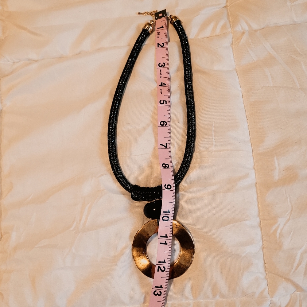 Black rope necklace with gold medal, black, and gray circle. - Picture 5 of 6